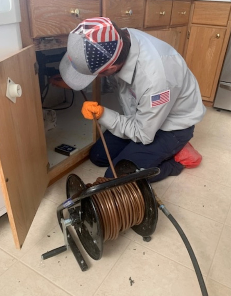 Technician running cable into cabinets