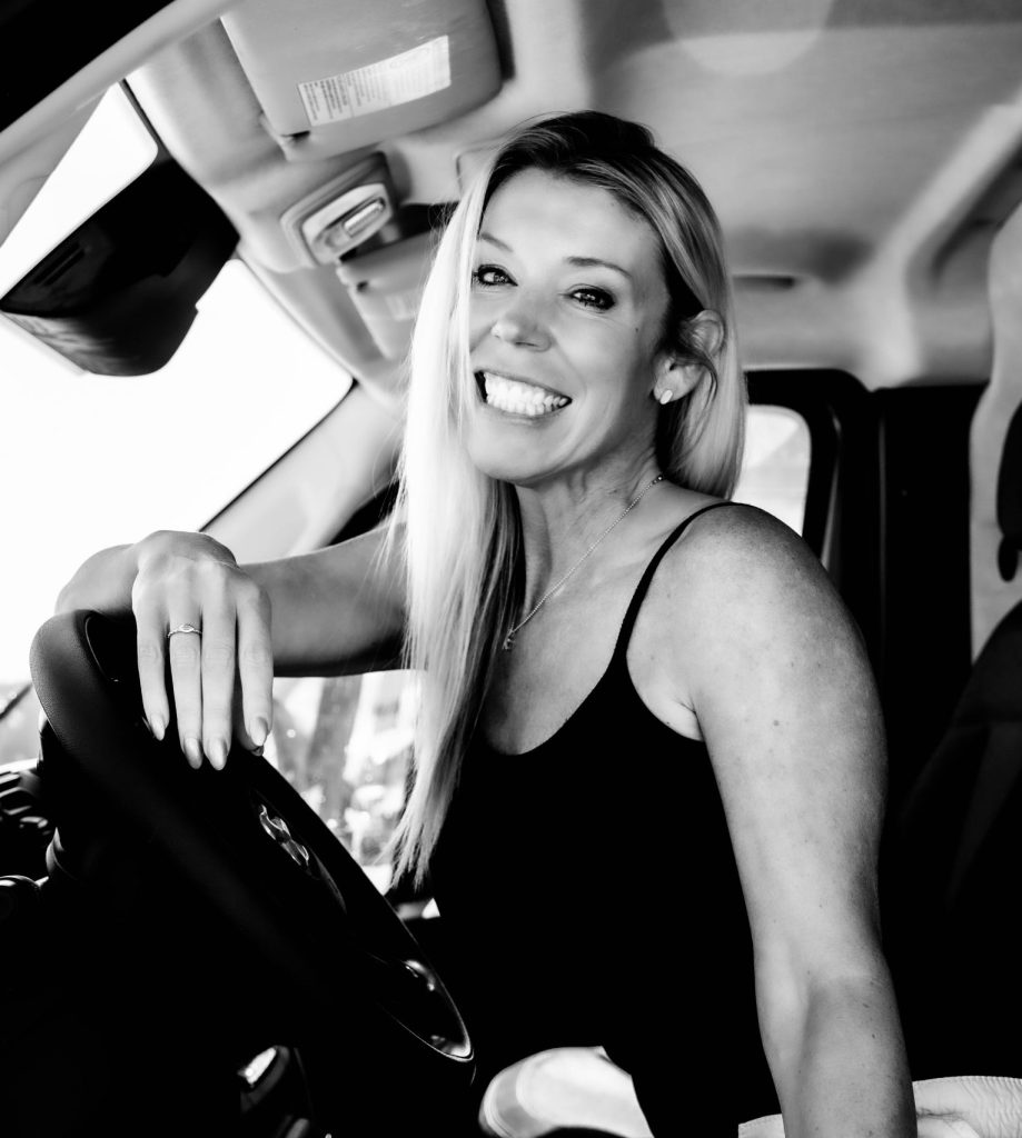 Kris Spurlin Headshot of her in a work van