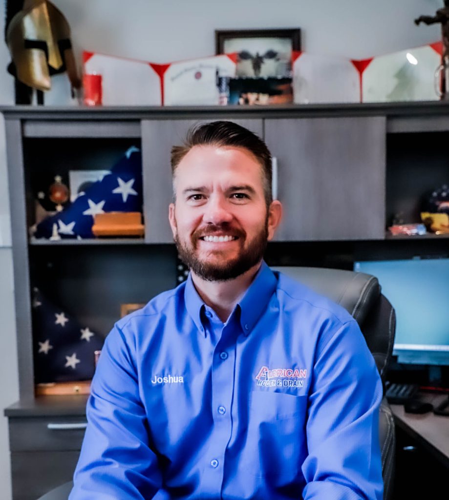 Joshua Jordan, Owner & CEO of American Rooter & Drain sitting at his desk